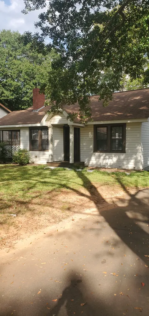 Front of the house and yard under a shade tree