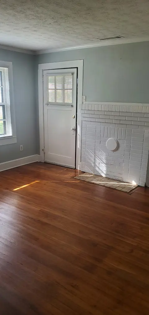 Front room with hardwood floors and the front door