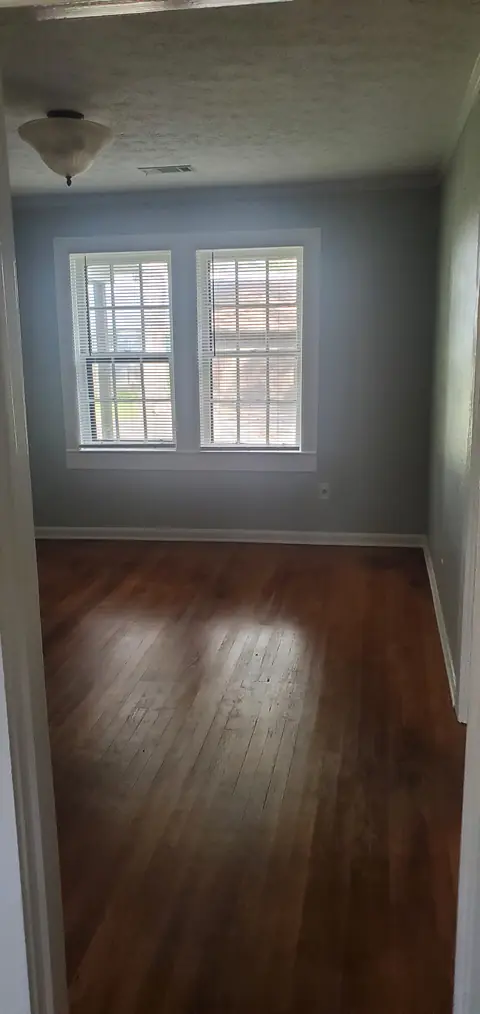 Room with hardwood floors and double windows