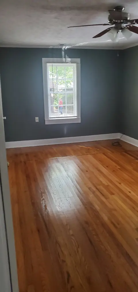Room with hardwood floors and a ceiling fan