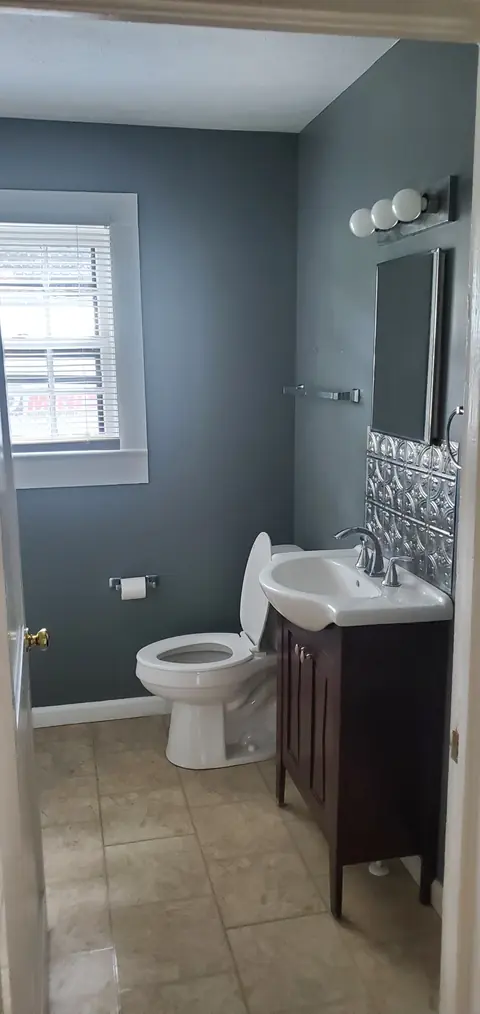 Bathroom with vanity and tile floor