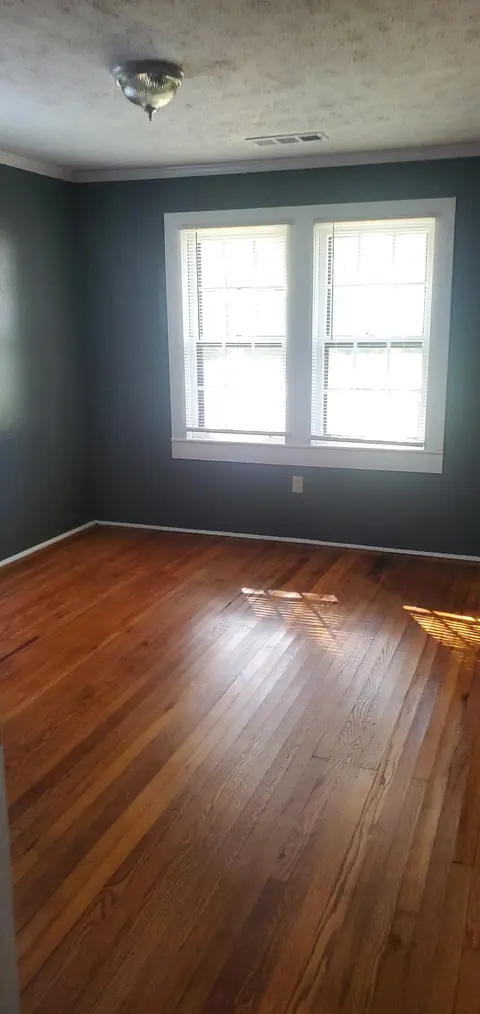 Room with hardwood floors and double windows